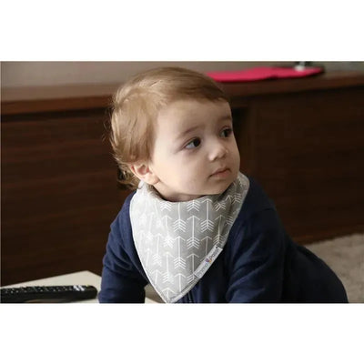 Bandana bib featuring a gray design with white arrows, worn by a toddler in a dark blue outfit.