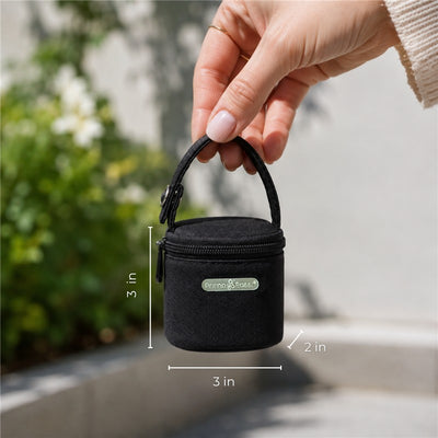 Compact black Primo Passi pacifier bag with a hand holding it, measuring 3 inches in height and width, 2 inches in depth.
