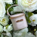 Stylish Primo Passi Pacifier Bag in light pink, showcasing a waterproof interior, compact design, and ease of access.