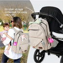 Beige Primo Passi PerTutti Baby Diaper Bag Backpack featuring stroller straps, carried by a woman with a child.