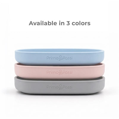 Primo Passi Silicone Suction Plates in blue, rose pink, and gray stacked, highlighting their availability in three colors.