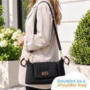 Primo Passi Nero Stroller Organizer shown as a sleek black bag being worn as a shoulder bag, with a gold hook and decorative handles.