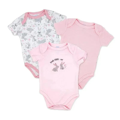 Three girl’s bodysuits in a set: one with a bunny print on a white background, two in pink, one featuring bunny artwork and text.
