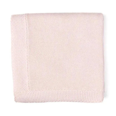 Knit blanket in coral with a textured border, showcasing a soft, cozy design suitable for home decor.