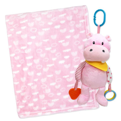 Plush pink hippo toy with a yellow bib and rattles, alongside a soft pink blanket featuring white cloud patterns.