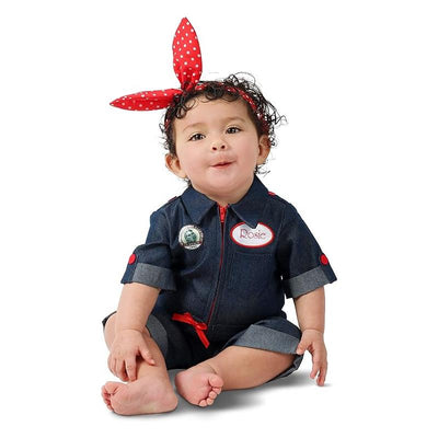 Toddler wearing a denim Rosie the Riveter costume with a red polka dot headband, displaying a cheerful expression.