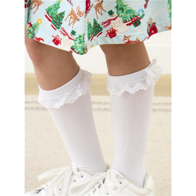 Knee-high white socks with lace ruffles and bows, worn by a child, complementing a festive patterned dress.
