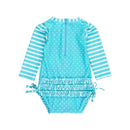 Aqua one-piece rash guard swimsuit for baby girls, featuring heart polka dots, striped sleeves, and a ruffled waist with ties.