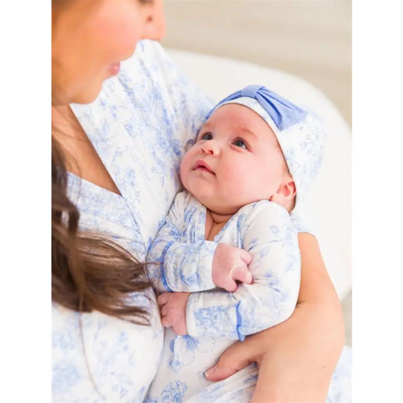 Baby in a blue butterfly-patterned knotted sleep gown and bow hat set, gazing at mother, showcasing soft fabrics.