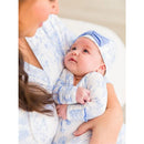 Baby in a blue butterfly-patterned knotted sleep gown and bow hat set, gazing at mother, showcasing soft fabrics.