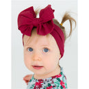Dark cherry big bow headband worn by an infant with blue eyes, complemented by a floral print outfit.