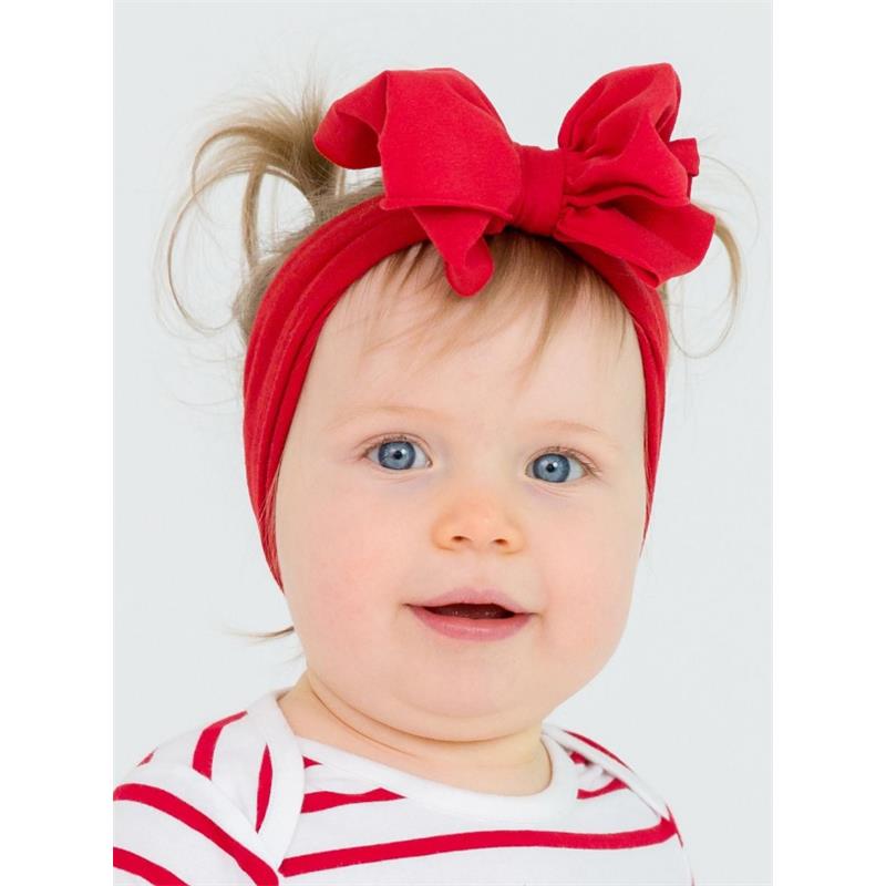 Red headband with a large bow worn by a smiling baby with light hair and blue eyes, dressed in a striped shirt.