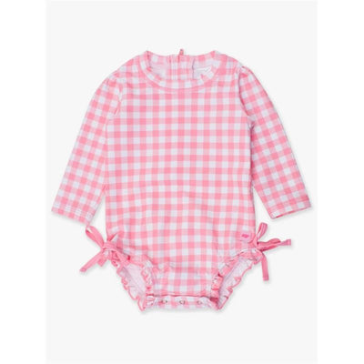 Long sleeve bubblegum pink one-piece rash guard with a checkered pattern and ruffle details at the legs.