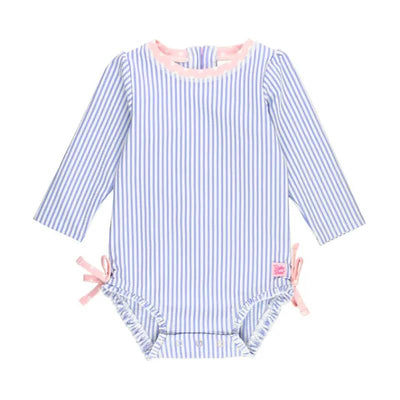 Periwinkle blue seersucker rash guard for infants, featuring long sleeves, pink trim, and bows on the sides.