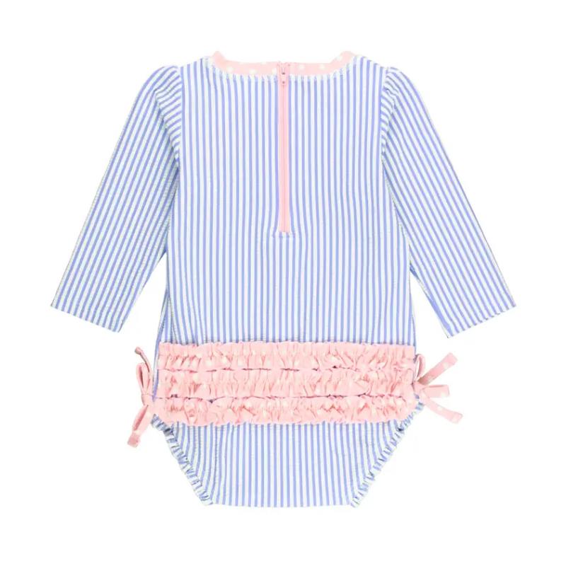 Periwinkle blue seersucker one-piece rash guard for infants, featuring long sleeves and a pink ruffled waistline.