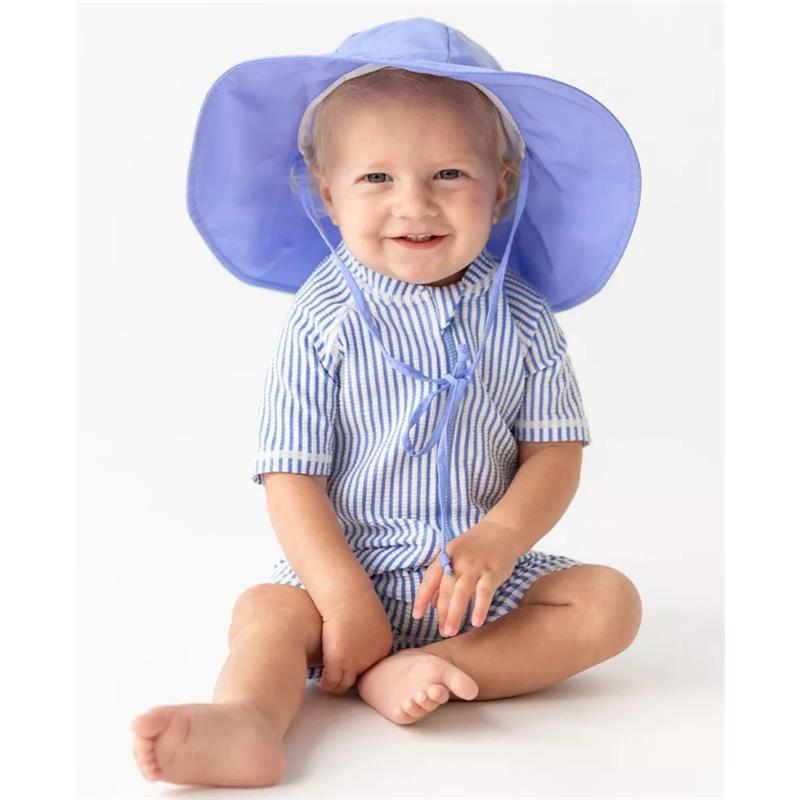 Light blue seersucker short sleeve one-piece rash guard on a smiling toddler, wearing a matching wide-brimmed hat.