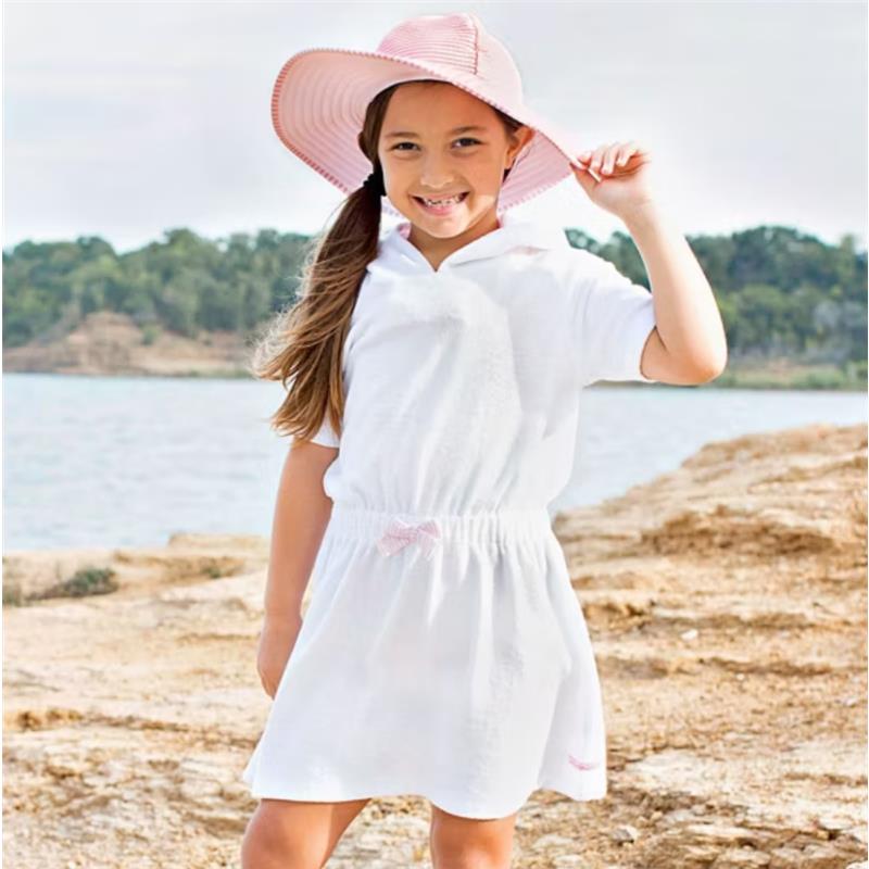 White terry cover-up for infants with pink seersucker accents, worn by a smiling girl by the water in a sun hat.