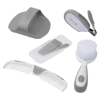 Gray Safety 1st Ready for Baby Deluxe Nursery Kit, featuring a comb, brush, nail clippers, and grooming tools.