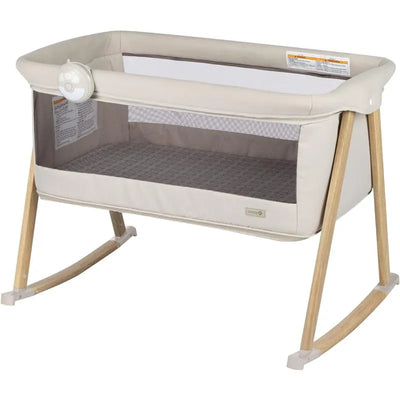 2-in-1 bassinet and play yard with soft fabric, mesh siding, and soothing sounds feature, designed for infants.