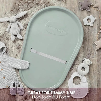 Squishy eucalyptus-colored baby changing diaper pad with a soft, non-toxic PU foam design, surrounded by baby items.