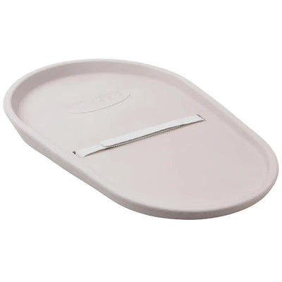 Squishy taupe baby changing diaper pad with a curved oval shape and a safety strap for securing the baby.