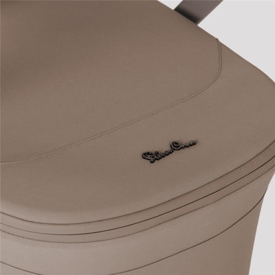 Champagne-colored fabric of the Silver Cross Breez Overnight Approved Folding Bassinet with logo detail.