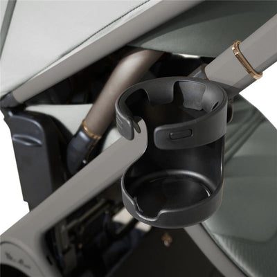 Black cup holder attached to the Silver Cross Cove 2 stroller frame, designed for holding beverages securely.