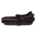 Silver Cross Reef 2 Folding Bassinet in Ganache color, featuring a compact design with a padded interior and carrying handle.