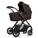 Silver Cross Reef 2 Folding Bassinet in Ganache color, featuring a sturdy frame, large wheels, and a retractable canopy.