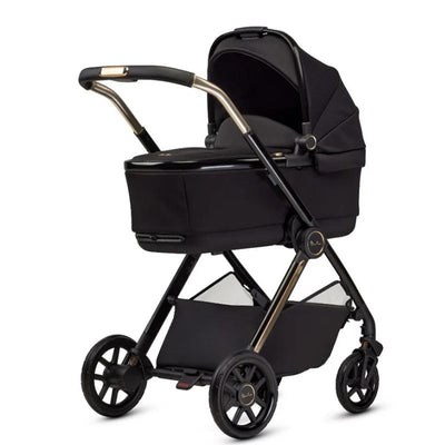 Silver Cross Reef 2 multi-terrain stroller in espresso with a bassinet attachment, featuring a sleek black design and gold accents.