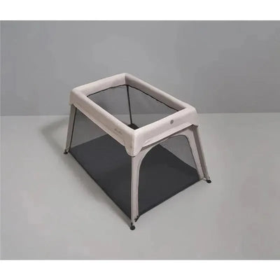 Sustainable Silver Cross Sleep & Go Travel Crib in Stone color, featuring mesh sides and a sturdy frame.