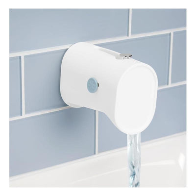 Soft silicone faucet safety guard with adjustable design, mounted on wall, protecting baby during bath time.
