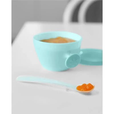 Teal and grey baby feeding set featuring a bowl with food and a matching spoon on a table.