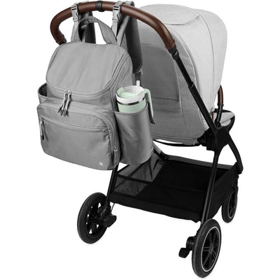 Skip Hop Diaper Bag Backpack in Forma Next Grey attached to a stroller, featuring multiple pockets and a side cup holder.