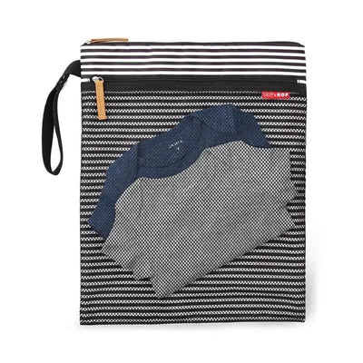 Black and white striped wet/dry bag by Skip Hop with a navy blue shirt partially visible inside.