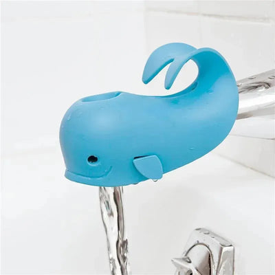Blue whale-shaped bath spout cover with a smile, designed to protect children during bath time.