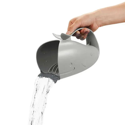 Grey whale-shaped water rinser pouring water from its mouth, designed for rinsing during bath time.