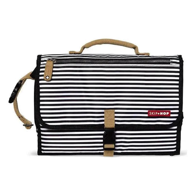 Portable baby changing pad by Skip Hop in black and white stripes, featuring a handle and secure closure.