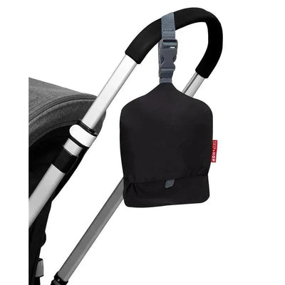 Black Skip Hop shopping cart cover attached to a stroller handle, providing protection and comfort for children.