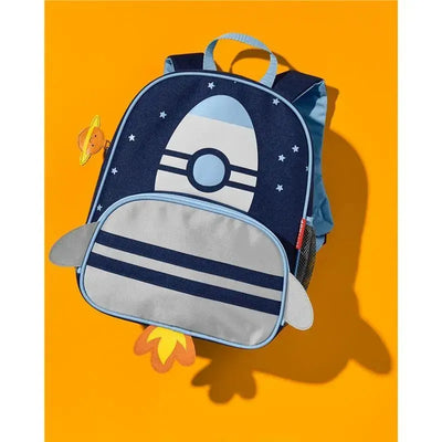 Skip Hop Spark Style Little Kid Backpack in rocket design, featuring stars, a gray front pocket, and a Saturn charm.