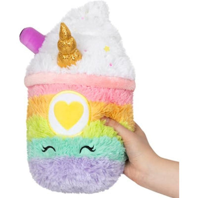 Plush Mini Unicorn Latte featuring rainbow colors, a golden horn, and a smiling face, being held by a hand.