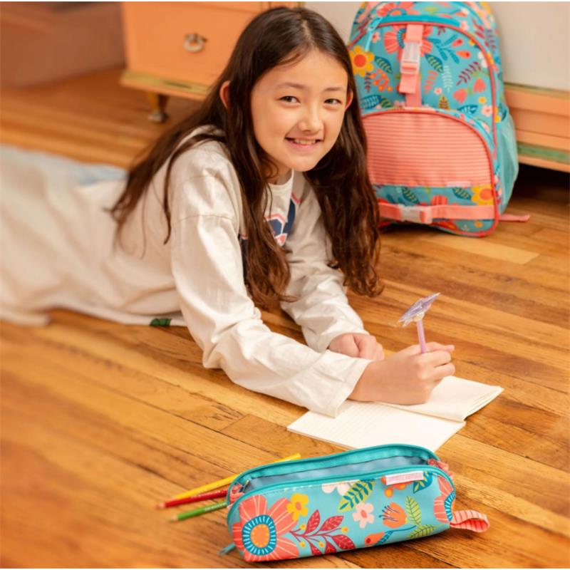 Colorful pencil pouch featuring a mermaid design, used by a girl writing in a notebook on the floor.