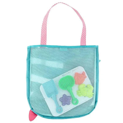 Mesh beach tote bag in teal with pink polka dot handles, containing sand toys in various colors: shovel, scoop, and molds.