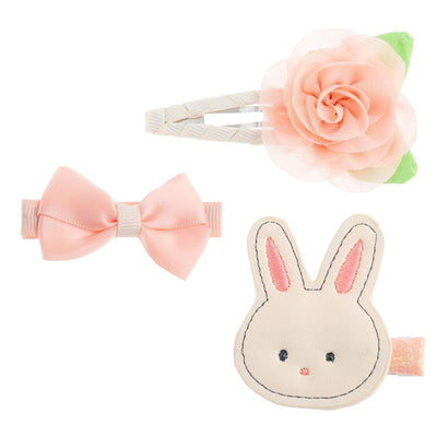 Set of three hair clips featuring a pink bow, a flower, and a bunny design, suitable for children.