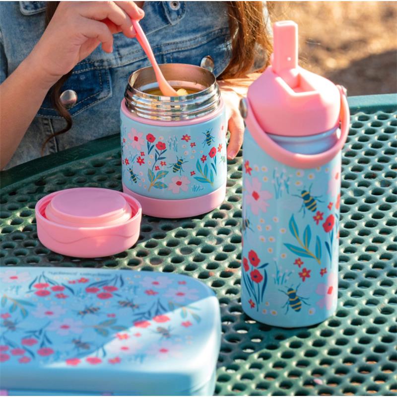 Insulated stainless steel bottle with handle and floral design, alongside a food container, on a picnic table.