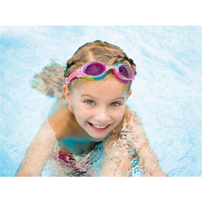 Child wearing colorful Stephen Joseph Mermaid Aqua swim goggles, smiling while playing in a pool.