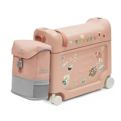 Coral pink Stokke Jetkids Travel Bundle featuring a wheeled suitcase with decorative stickers and a removable backpack.