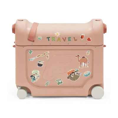 Coral pink Stokke Jetkids travel bundle suitcase featuring various playful stickers, including animals and travel motifs.