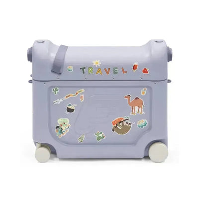 Stokke Jetkids™ Bedbox™ in Arctic Blue, featuring colorful travel-themed stickers and wheels for easy mobility.
