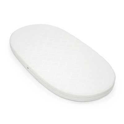 Oval white mattress for Stokke Sleepi, featuring a quilted surface design and a zippered edge.